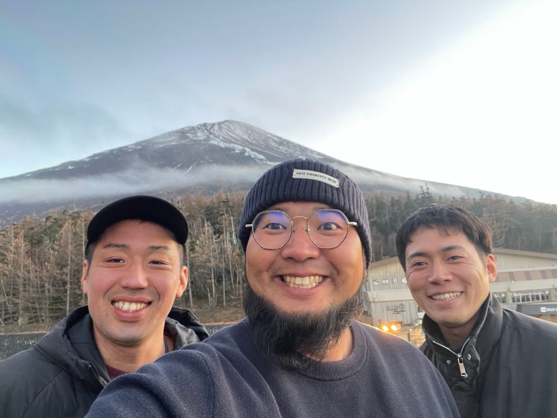 Hiro, Taiki and Hayato smiling together in front of Mt. Fuji