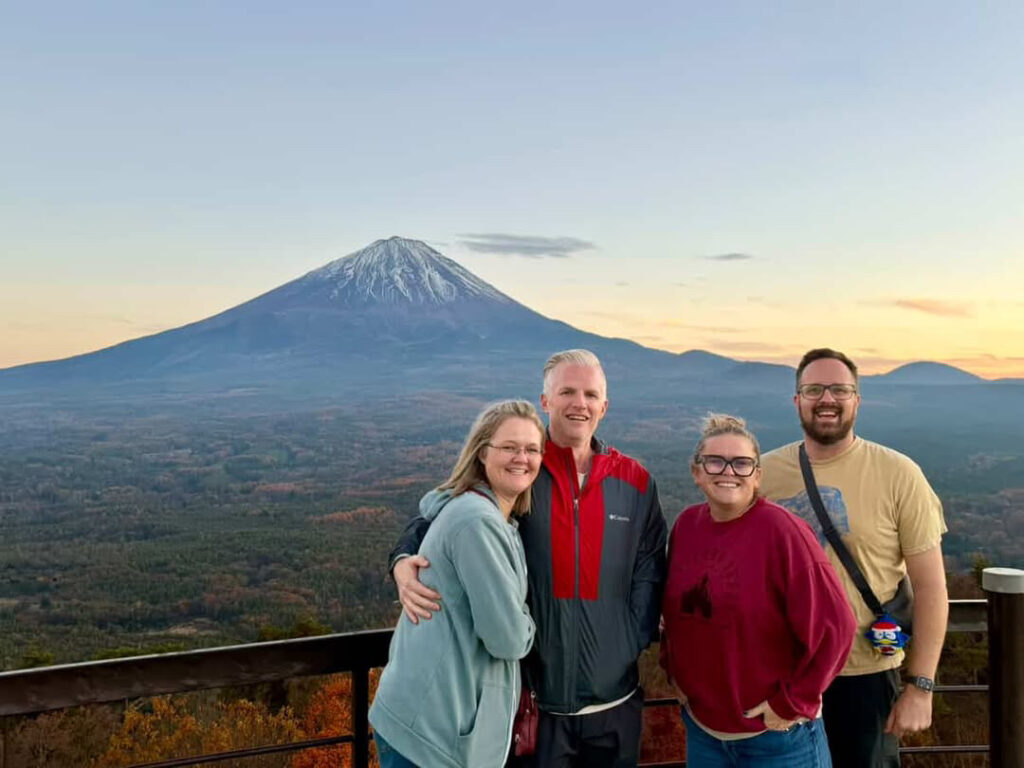 A private group of four guests at a viewpoint with Mt. Fuji behind them