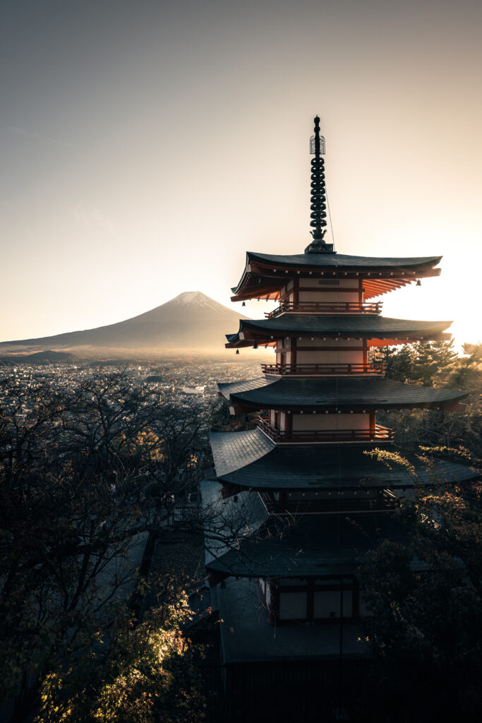 Chureito Pagoda glowing in the low autumn sun, with Mt. Fuji beyond